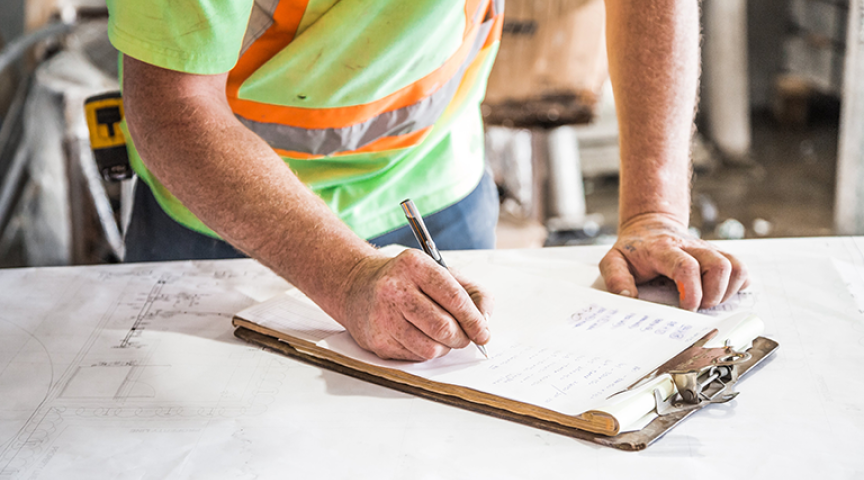 Contractor checks off items on a clipboard