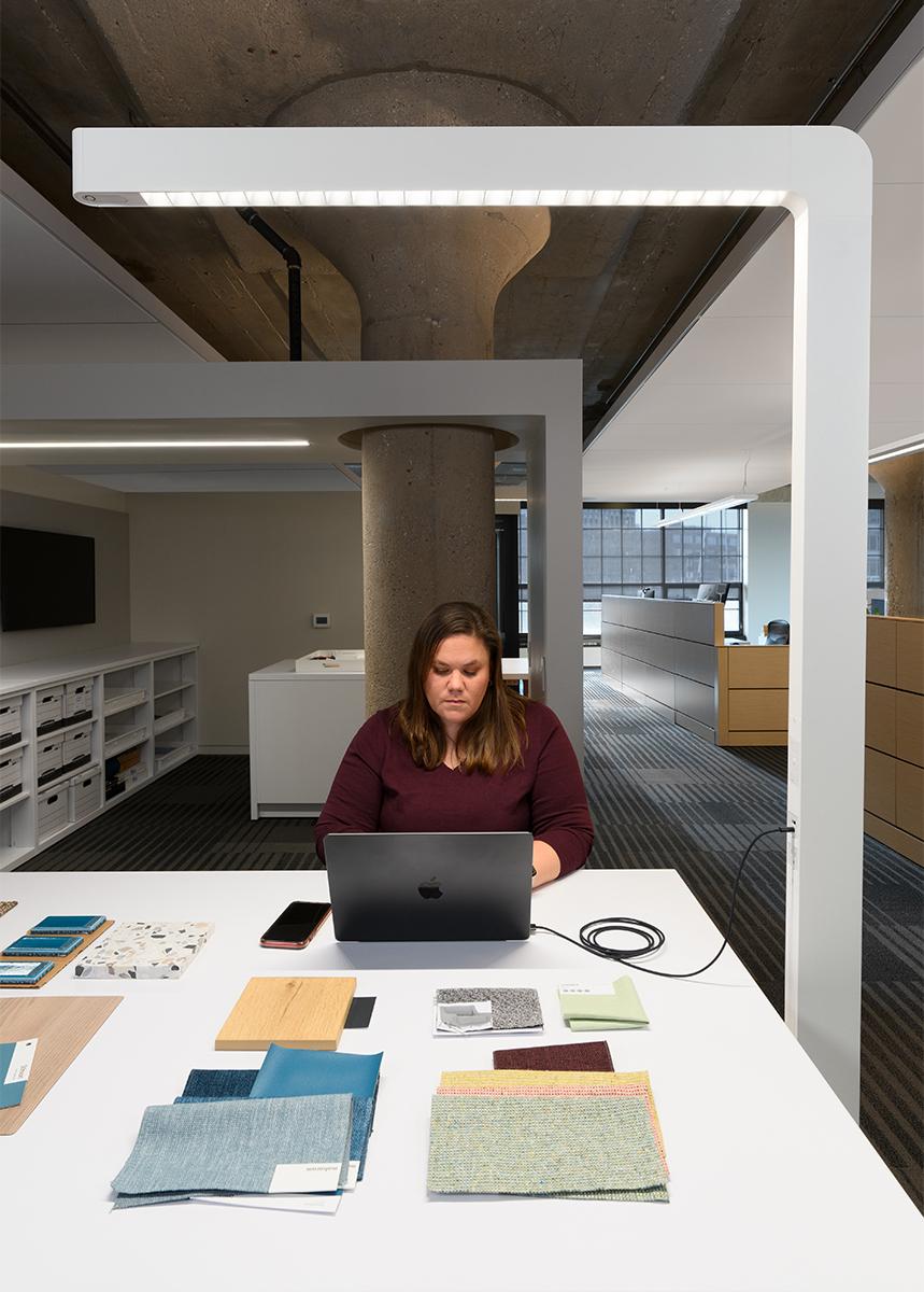 Tazo Single Sans-Serif over a woman working at HGA Milwaukee